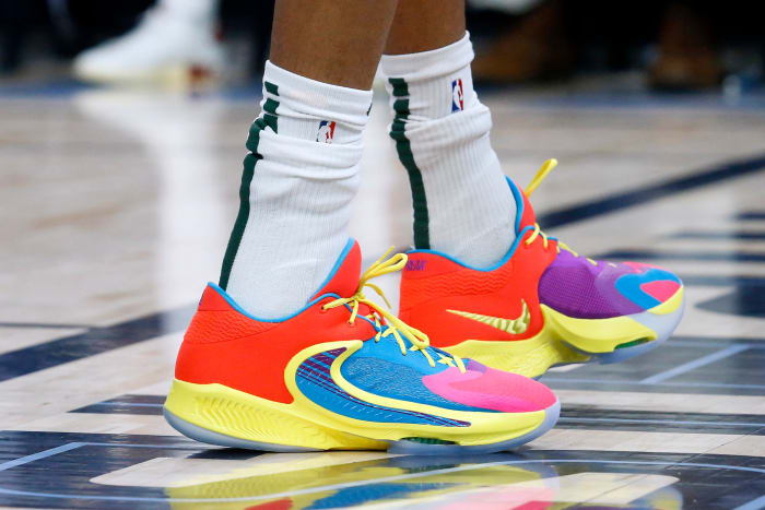 View of Giannis Antetokounmpo's red and yellow Nike shoes.